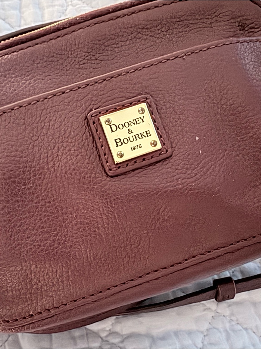 Dooney & Bourke Burgundy Crossbody Bag with Gold Logo Plaque